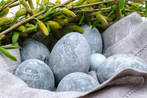 Easter background. Close-up of marble-colored Easter eggs in a linen napkin w Stock Photos