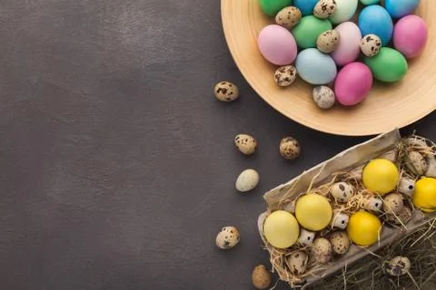 Easter background. Colored eggs on gray stone surface 스톡 사진