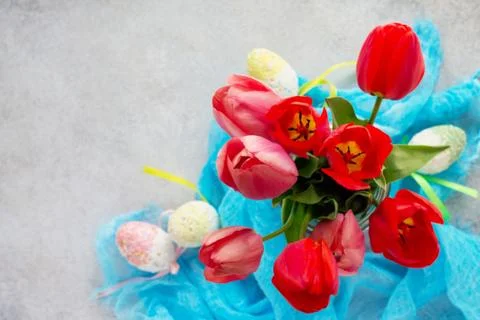 Easter background. Colorful background of Easter with tulips, colored eggs. Stock Photos