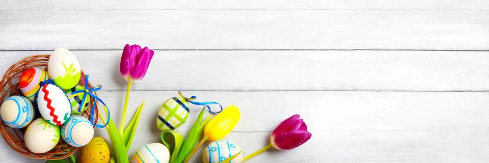 Easter background with colorful easter eggs on wooden background. Stock Photos