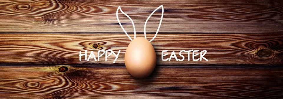 Easter background with colorful easter eggs on wooden background. Stock Photos