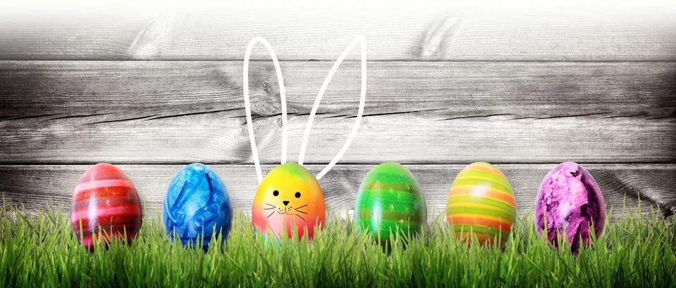 Easter background with colorful easter eggs on wooden background. Stock Photos