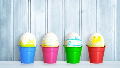 Easter background with colorful easter eggs on wooden background. Stock Photos