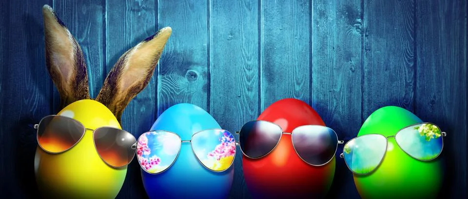 Easter background with colorful easter eggs on wooden background. Stock Photos