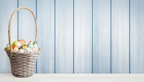 Easter background with colorful easter eggs on wooden background. Stock Photos