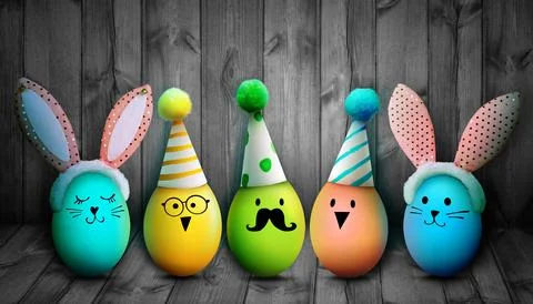 Easter background with colorful easter eggs on wooden background. Stock Photos