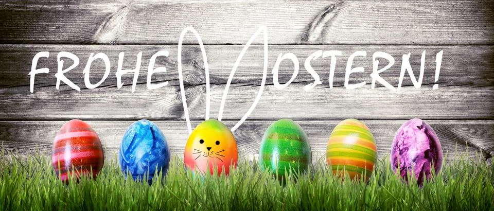 Easter background with colorful easter eggs on wooden background. Stock Photos