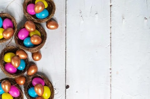 Easter background. Colourful easter eggs in nests. Stock Photos