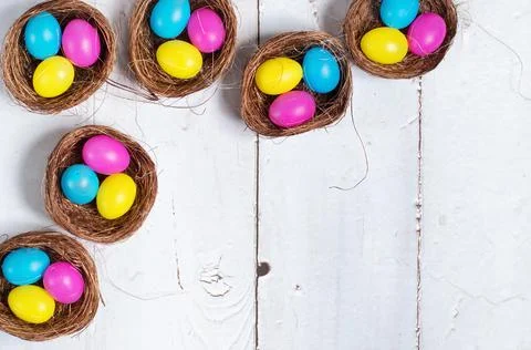 Easter background. Colourful easter eggs in nests. Stock Photos