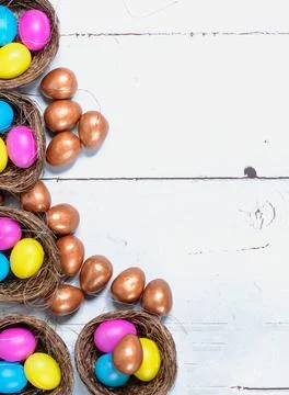 Easter background. Colourful easter eggs in nests. Stock Photos