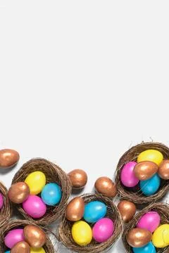 Easter background. Colourful easter eggs in nests. Stock Photos