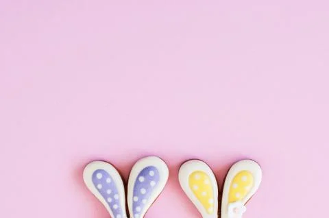 Easter background concept. Bunny ears cookies on a pink background. Stock Photos