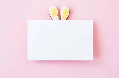 Easter background concept. Easter bunny ears under white empty paper on a pin Stock Photos