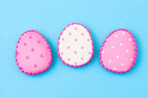 Easter background concept. Polka dot easter egg cookies on a blue background. Stock Photos