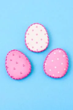 Easter background concept. Polka dot easter egg cookies on a blue background. Stock Photos