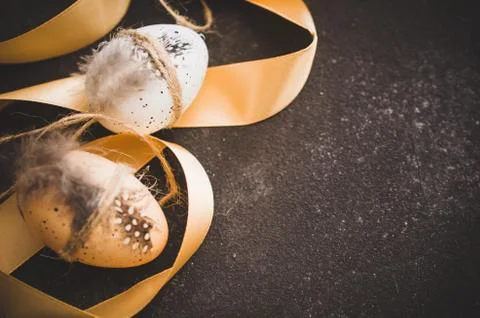 Easter background with decorative easter eggs and ribbon. Stock Photos