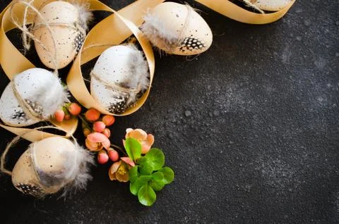 Easter background with decorative easter eggs and flowering spring branch. Stock Photos