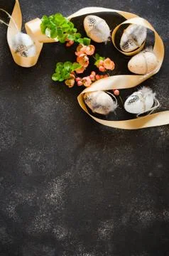 Easter background with decorative easter eggs and flowering spring branch. Stock Photos