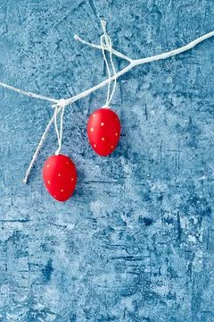 Easter background. Decorative red Easter eggs on white branch. Copy space Stock Photos