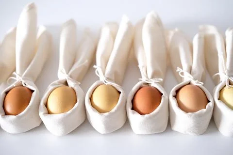 Easter background with an Easter bunny from a linen napkin and eggs. Stock Photos