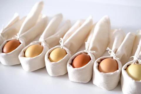 Easter background with an Easter bunny from a linen napkin and eggs. Stock Photos