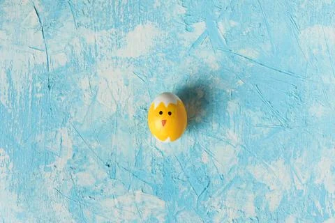 Easter background, Easter egg decorated as chic on blue textured background. Stock Photos