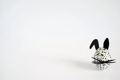 Easter background with easter egg decorated as spotted black and white bunny Stock Photos