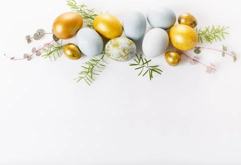 Easter background with Easter eggs and spring flowers. Top view with copy spa Stock Photos