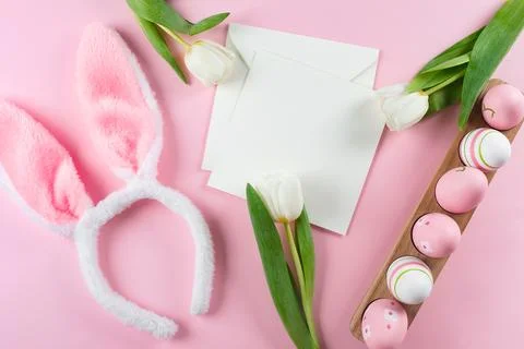 Easter background with easter eggs, fluffy bunny ears, white tulips and emp.. Stock Photos