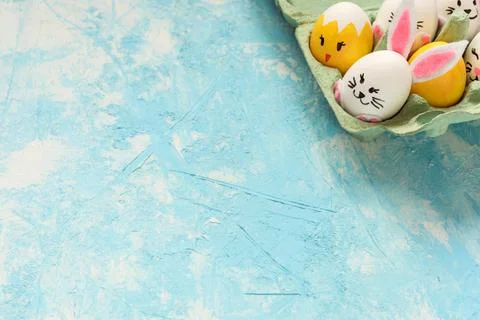 Easter background, Easter eggs painted as chicks and rabbits on blue background. Stock Photos