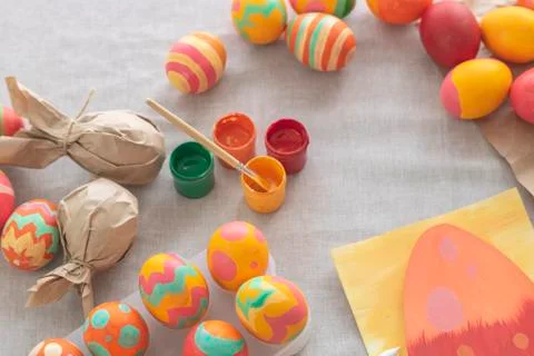 Easter background with Easter multi-colored eggs, paints and a card on the ta Stock Photos