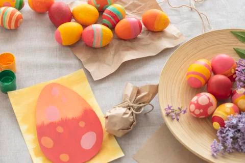 Easter background with Easter multi-colored eggs, paints and a card on the ta Stock Photos