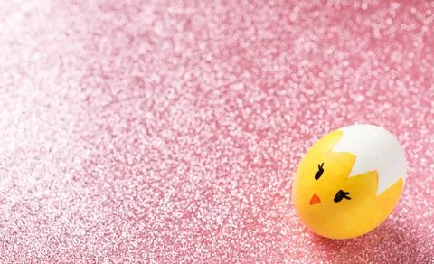 Easter background, Easter painted egg on the pink shiny texture. Copy space. Stock Photos