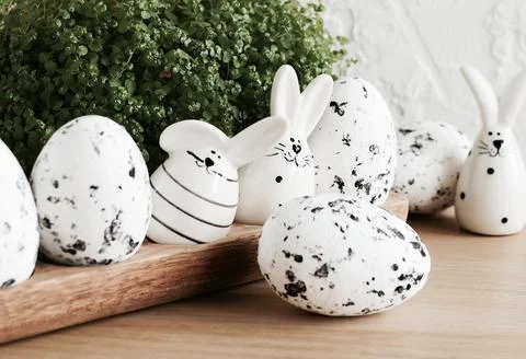 Easter background. Eggs and Easter bunny on wooden backdrop.  Copy space Stock Photos