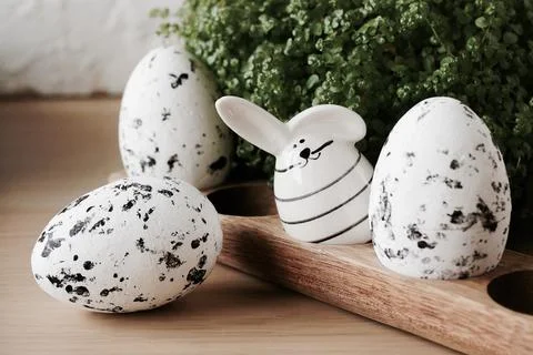 Easter background. Eggs and Easter bunny on wooden backdrop.  Copy space Stock Photos