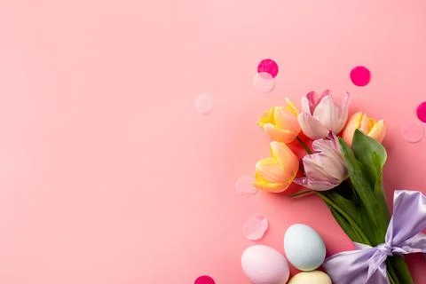 Easter background with eggs and tulips on pink backdrop, top view flat lay Stock Photos