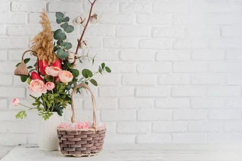 Easter background with eggs in basket and spring flowers in vase Stockfoto's