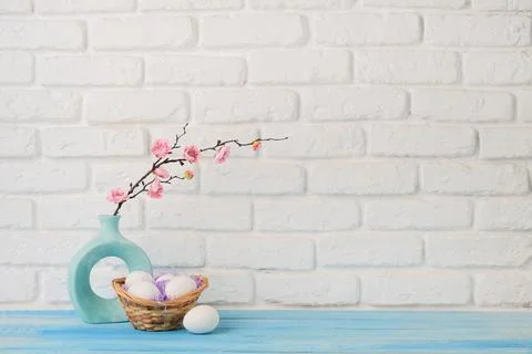 Easter background with eggs in basket, spring flower and white frame for mock 库存照片