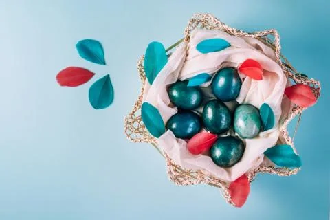 Easter background with eggs decorated in blue, turquoise and gold in nest with Stock Photos