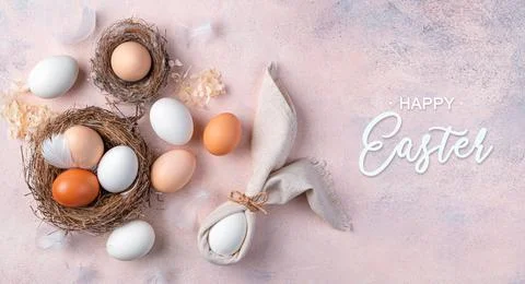 Easter background with eggs in a nest and an Easter bunny from a napkin on a  Stock Photos