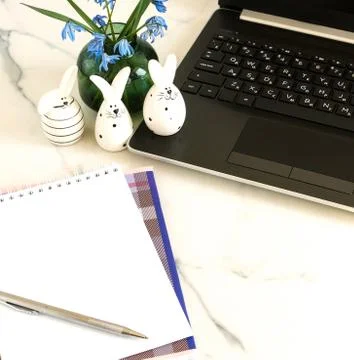 Easter background. Flat lay office table, workspace with laptop, Easter bunn Stock Photos