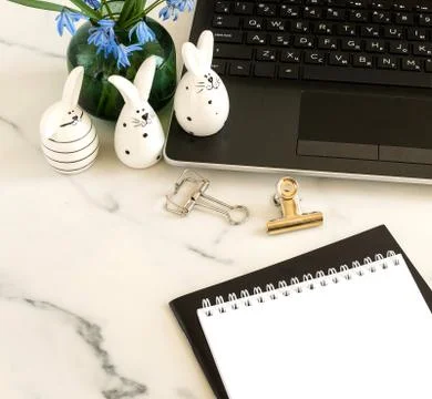 Easter background. Flat lay office table, workspace with laptop, Easter bunn Stock Photos
