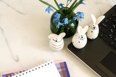 Easter background. Flat lay office table, workspace with laptop, Easter bunn Stock Photos
