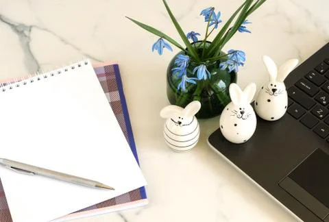 Easter background. Flat lay office table, workspace with laptop, Easter bunn Stock Photos