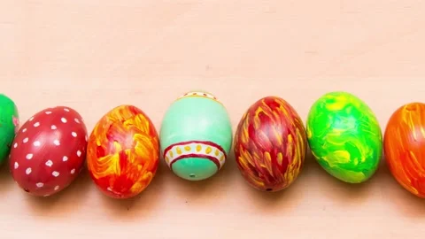 Easter background with handmade colored eggs. Top view. Festive tradition Stock Footage 235308037