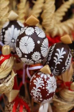 Easter background made of painted eggs and straw products, vertical frame Stock Photos