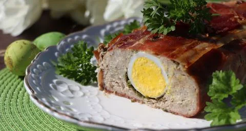 Easter background. Meatloaf wrapped in bacon with eggs Stock Photos