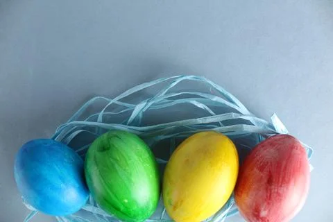 Easter background multicolored painted eggs blue green yellow red on a light Stock Photos