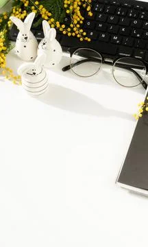 Easter background. office table desk, workspace with laptop, easter bunny,  bouq Stock Photos