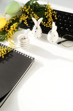 Easter background. office table desk, workspace with laptop, easter bunny,  bouq Stock Photos